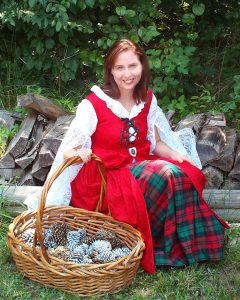 Author Jennifer Hudson Taylor wearing a red Celtic gown