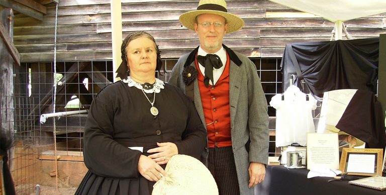 Man and woman wearing Victorian mourning clothing